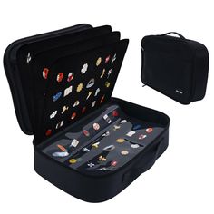 an open black case filled with lots of pins and magnets on the inside of it