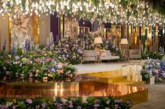 a room filled with lots of flowers and chandeliers