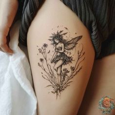 a woman's thigh with a tattoo on it