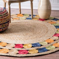 a round rug with multicolored circles on it and a chair in the background