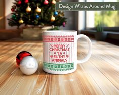 a coffee mug sitting on top of a wooden table next to a christmas ornament