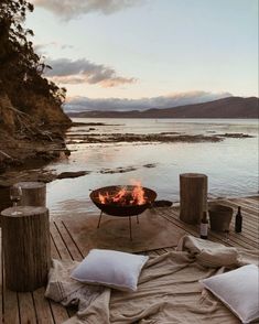 a fire pit sitting on top of a wooden dock