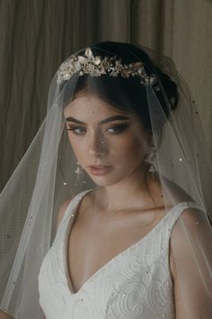 a woman wearing a veil with flowers on it