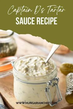 a jar filled with sauce sitting on top of a wooden cutting board