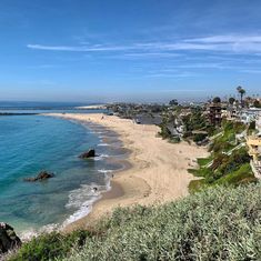 the beach is lined with houses and trees near the water's edge, along with an ocean view