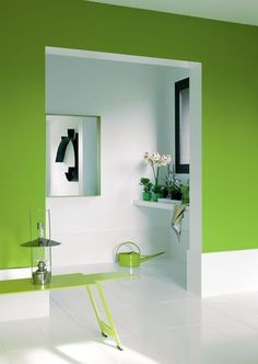 a room with green walls and white floors