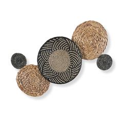 three woven baskets sitting next to each other on top of a white surface with black dots