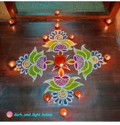 an artistic design on the ground with candles in it for diwaling or decorating