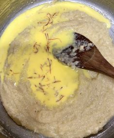 a wooden spoon mixing batter in a metal bowl