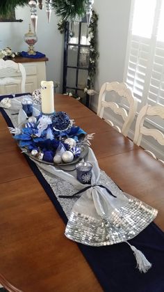 a dining room table with blue and silver decorations