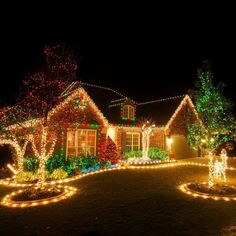 christmas lights decorate the front yard of a house