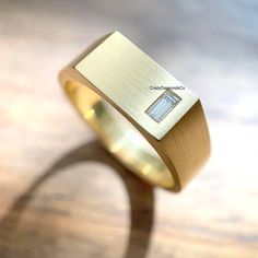 Classic Design Signet Ring, 4X2 MM Baguette Cut Lab Diamond Wide Band Men's Ring, 14k Yellow Gold Satin Finish Ring, Handcrafted Wide Band ✹✹𝐖𝐞𝐥𝐜𝐨𝐦𝐞 𝐭𝐨 𝐂𝐫𝐚𝐳𝐲𝐃𝐢𝐚𝐦𝐨𝐧𝐝𝐬𝐂𝐨✹✹ Detail about stones Moissanite & Simulated Stone: ----------------------------- Stone Shape: Baguette Cut Stone Size: 4X2 mm Weight: 0.14 CT Color: Colorless Cut: Excellent Clarity: VVS Lab-Grown Diamond & Natural Diamond: ----------------------------- Stone Shape: Baguette Cut Stone Size: 4X2 mm Weight: 0.14 CT Color: FG Cut: Excellent Clarity: VS-SI ★ 𝑰𝒕𝒆𝒎 𝑫𝒆𝒕𝒂𝒊𝒍𝒔:- ☛ Metal Purity: Solid Gold (10KT, 14KT, 18KT); Silver(925 Sterling, 935 Argentium), 950 Platinum ☛ Metal Tone: Yellow, White, Rose ☛ Stamp/Hallmark: Yes ★ 𝑪𝒖𝒔𝒕𝒐𝒎𝒊𝒛𝒂𝒕𝒊𝒐𝒏:- ☛ Customized Design Jewelry. ☛ All cuts Cheap Gold Men's Ring In Stainless Steel, Luxury Men's Ring With Polished Edges, Luxury Men's Gold Ring With Polished Edges, Luxury Men's Rings With Smooth Finish, Luxury Thick Band Men's Ring In Fine Jewelry Style, Luxury Men's Engagement Ring With Polished Edges, Luxury Men's Promise Ring With Wide Band, Luxury Men's Wedding Ring With Baguette Cut, Men Wedding Ring Diamond Simple