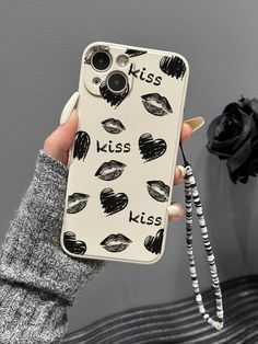 a person holding up a phone case with lipstick prints on the front and back of it