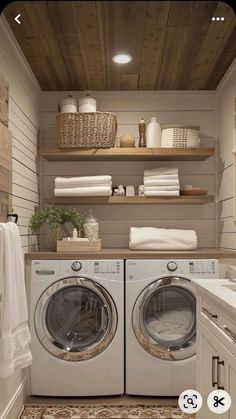 a washer and dryer in a small room with shelves above the washer