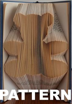 an open book with folded pages and the words pattern on it