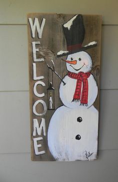 a wooden sign with a snowman painted on it