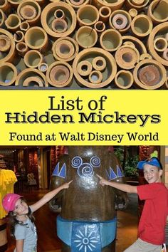 two children standing in front of a pile of wooden pipes with the title list of hidden mickey's found at walt world