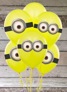 a bunch of yellow balloons with minion faces on them