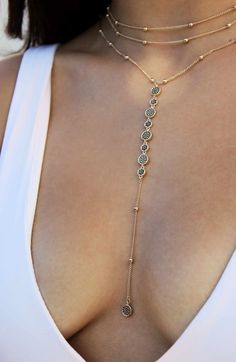 Glittering cubic zirconia stones catch the light on a multichain necklace in 18-karat gold plate. 15" longest strand length; 12 1/2" shortest strand length5" extender 6" pendant drop, 1/4" width Lobster clasp closure 18k-gold plate/cubic zirconia Imported Body Chain Jewelry, Jewelry Inspo, Lariat Necklace, Pretty Jewellery, Piercing Jewelry