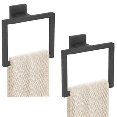 two black square towel holders with white towels