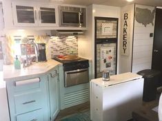 a kitchen with blue cabinets and white counter tops