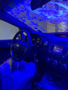 the interior of a car with blue lights