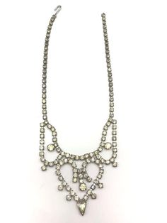 Very pretty Rhinestone Trifari necklace. Radiant necklace hallmarked Trifari on clasp measure approx 15 inches long (bib portion is 2 1/4 inches high by 5 inches long) Beautiful weeding or formal jewelry set. All rhinestones shimmer -set in excellent condition! This set would make a great gift lovely addition to any jewelry collection. Comes in jewelry gift box-Free domestic shipping! Refunds and Exchanges We do accept returns within 30 days of the purchase of the item. However, the buyer is res Antique Crystal Necklaces For Wedding, Antique Crystal Necklace For Formal Occasions, Antique Crystal Wedding Necklaces, Vintage Stone Necklace For Wedding, Antique Rhinestone Necklaces For Formal Occasions, Costume Jewelry Bridal Necklace For Anniversary, Formal Jewelry, Bib Necklaces, Rhinestone Necklace