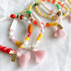 Sustainable multi-colored bead and semi-precious stone bracelet. Features vintage, antique beads, turquoise, shell, vintage coral, garnet, amazonite, jade, howlite, and freshwater pearls. Pink cotton tassel. Perfect for ages 8-18. Free adjustments email us at: orders@bellestyle.com. Measures 6.5-7.5” stretch band. Sterling silver BelleStyle logo tag. Each bracelet is one of a kind. Comes in a linen travel pouch. Made with love in Wildwood, Mo USA. Multicolor Bohemian Bracelets With Dangling Beads, Multicolor Bohemian Friendship Bracelets With Gemstone Beads, Bohemian Bracelets With Dangling Beads For Gift, Adjustable White Beaded Bracelets With Dangling Beads, Beaded Bracelets With Tassels For Beach, Gift Bracelet With Tassels And Round Beads, Gift Bracelets With Tassels, Bohemian Multicolor Beaded Bracelets With Tassels, Bohemian Multicolor Tassel Bracelets