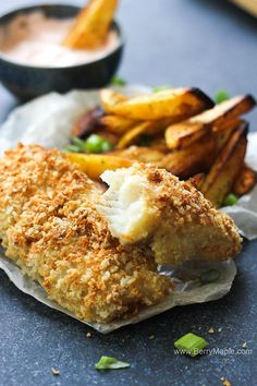 fried fish and fries with dipping sauce on the side