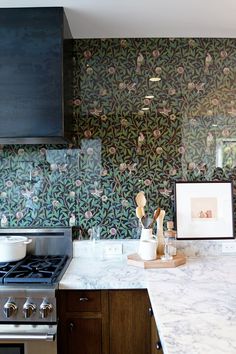 an image of a kitchen with wallpaper in the background