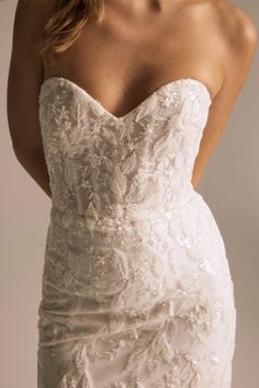 a woman in a wedding dress with her hand on her hip and the back of her head