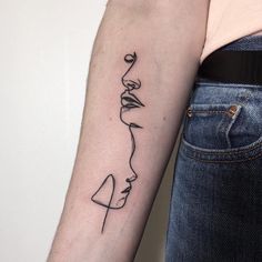 a woman's arm with a black line drawing on the left side of her arm