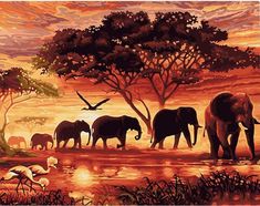 a group of elephants walking across a river under a sky filled with clouds and birds