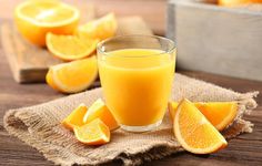 orange juice in a glass on a wooden table