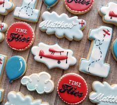 decorated cookies are arranged on a table for someone's first time pilot birthday party