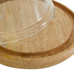 a wooden tray with a glass lid on it