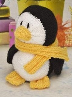 a stuffed penguin with a scarf around its neck