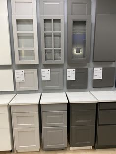 the cabinets are all different colors and sizes in this display area with labels on them