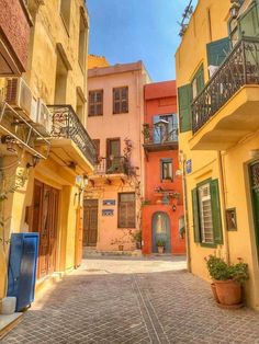 an alley way with several buildings and balconies