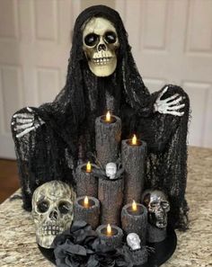 a skeleton sitting on top of a pile of candles