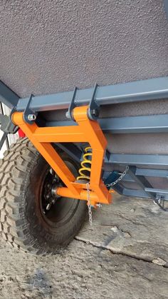 an orange tow dolly attached to the side of a building