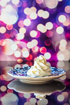 a plate that has some kind of dessert on it with lights in the back ground