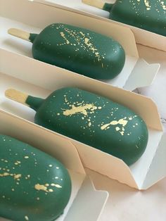 four green and gold ice cream popsicles in white boxes