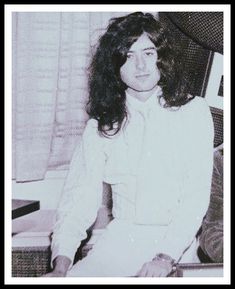 an old photo of a woman sitting on a chair