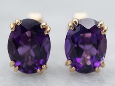 Fit for royalty, these earrings feature bright bursts of color from the amethysts and an excellent shine from every facet. The perfect size to transition from day to evening, these lovely earrings are sure to be a favorite of your jewelry wardrobe.Metal: 14K Yellow GoldGem: 2 Amethyst totaling 2.22 CaratsGem Measurements: 5.8 x 7.8 mm, OvalMarks: “14K” Stamped on the Findings Purple Oval Fine Jewelry Earrings, Classic Purple Gemstone Earrings, Purple Oval Earrings With Gemstone Accents, Jewelry Wardrobe, Amethyst Studs, Amethyst Gold, February Birthstone, Lovely Necklace, Amethyst Earrings