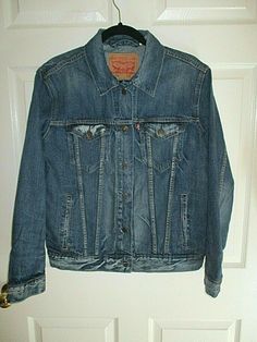 NOTE: I HAVE REPLACED THE SECOND BUTTON. SO, ALTHOUGH IT LOOKS ALMOST IDENTICAL, IT DOES NOT SAY LEVI STRAUSS ON THIS BUTTON.  NEW, IN PERFECT CONDITION, AUTHENTIC, LEVI STRAUSS, LEVI'S DENIM TRUCKER JACKET, IN DISTRESSED BLUE WASH. MEN'S SIZE LARGE, BUT THESE RUN SMALLER IN SIZE, SO I AM LISTING AS A MEDIUM. THEY ARE PRE-SHRUNK: PLEASE SEE MEASUREMENTS.   MATERIAL IS COTTON DENIM, MEDIUM THICKNESS, MORE SUPPLE THAN STIFF. FULL BUTTON CLOSURE.   NOTE: I HAVE A FEW OTHER SHADES, SEPARATELY LISTED Levis Denim Jacket, Denim Trucker Jacket, Denim Blue Jeans, Blue Jean Jacket, Jeans Jacket, Denim Jacket Men, Levis Denim, Men Vintage, Trucker Jacket