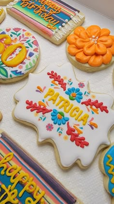 decorated cookies with happy birthday written on them are displayed in front of a white background