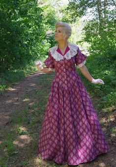 This charming cotton print prairie dress has flattering V-shape waist and neckline. The dress has contrasting solid cotton lace trimmed collar and lace flounced short sleeves. The three-paneled skirt has pockets. Hand wash or machine wash gently. The model is wearing a crinoline and gloves which are priced separately. Designed and made proudly by Recollections in America! Hand or machine wash cold gently; tumble dry low or hang to dry. Proudly made in the USA by the Recollections team. Crinoline Retro Short Sleeve Dresses With Lace Trim, Cotton Peasant Prairie Dress, Short Sleeve Prairie Dress With Ruffles For Garden Party, Fitted Short Sleeve Prairie Dress For Daywear, Short Sleeve Yoke Dress For Daywear, Short Sleeve Dress With Yoke For Daywear, Cotton Regency Dress With Lace Trim, Prairie Style Ruffled Dresses For Daywear, Pastoral Cotton Dresses With Lace Trim