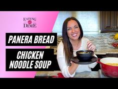 a woman holding a pan filled with chicken noodle soup