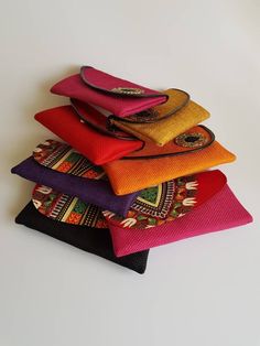 "100% handmade using African fabric, jute fabric and beads. This listing is for All 7 clutches. Dimensions; 11\" by 6\" *Fully lined. *Small coin pocket inside with a zipper. Perfect for weddings, African themed events, casual, evening etc. ♡Makes a perfect gift. **Buy multiple items and pay shipping for one item only." Handmade Jute Clutch Bag, Traditional Jute Bags As Gifts, African Bag, Beaded Clutch Bag, Plastic Canvas Stitches, Beaded Collar Necklace, Multi Strand Beaded Necklace, Jute Fabric, Handmade African